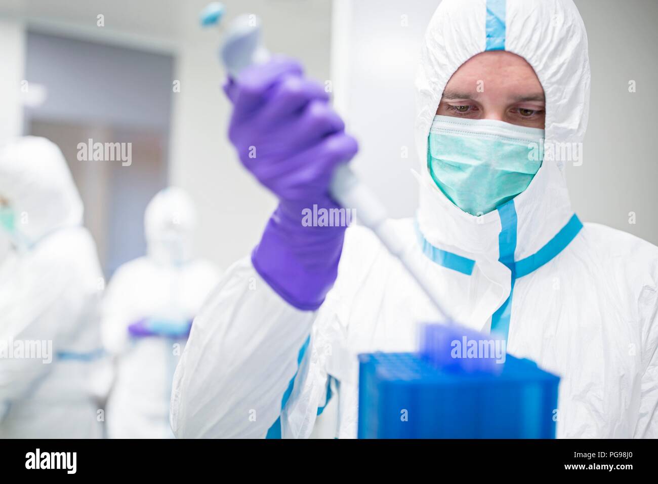 Technician working with cell samples in in a laboratory that engineers human tissues for implant. Such implants include bone and skin grafts. Stock Photo