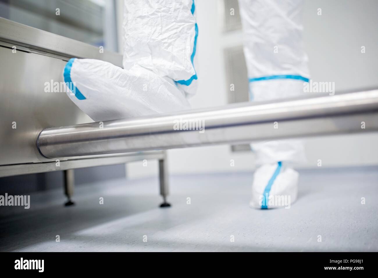 Close-up of a technician walking through a decontamination cabin before entering a sterile laboratory. Stock Photo