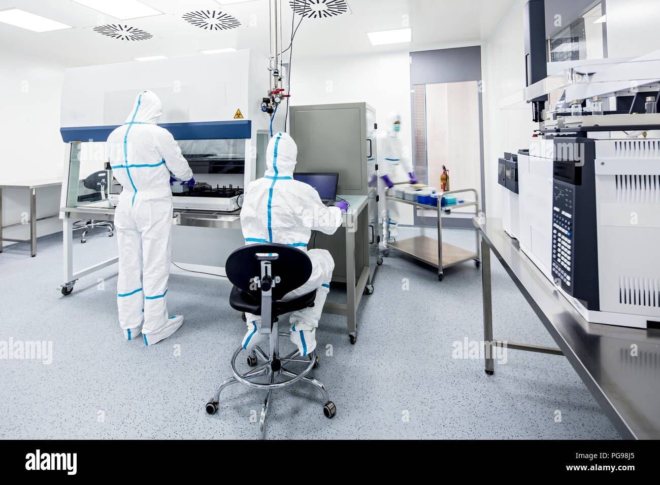 Technicians preparing and checking samples in a laboratory that manufactures human tissues for implant. Such tissues include bone and skin grafts. Stock Photo