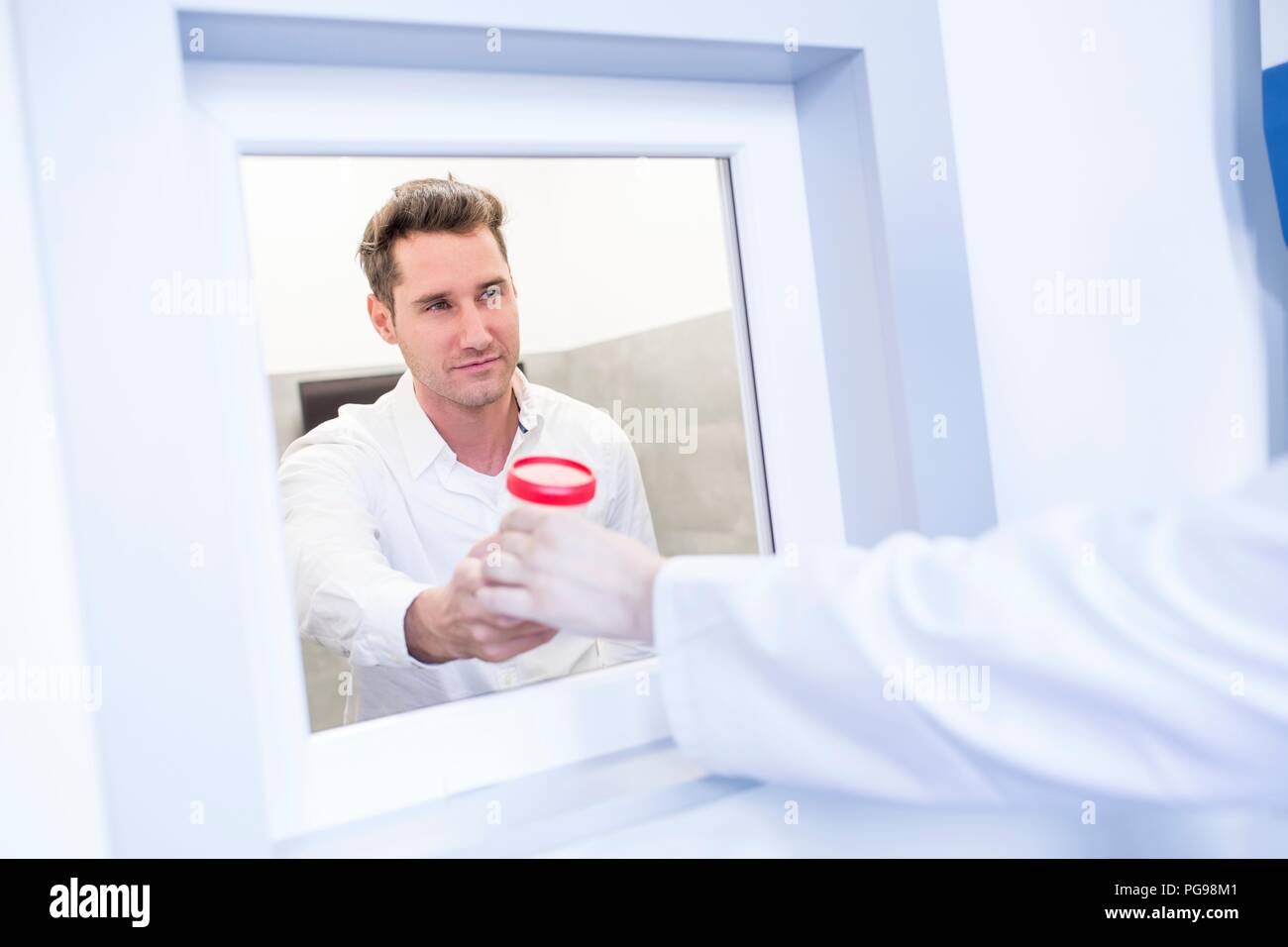 Sperm sample being handled in a fertility clinic. Stock Photo