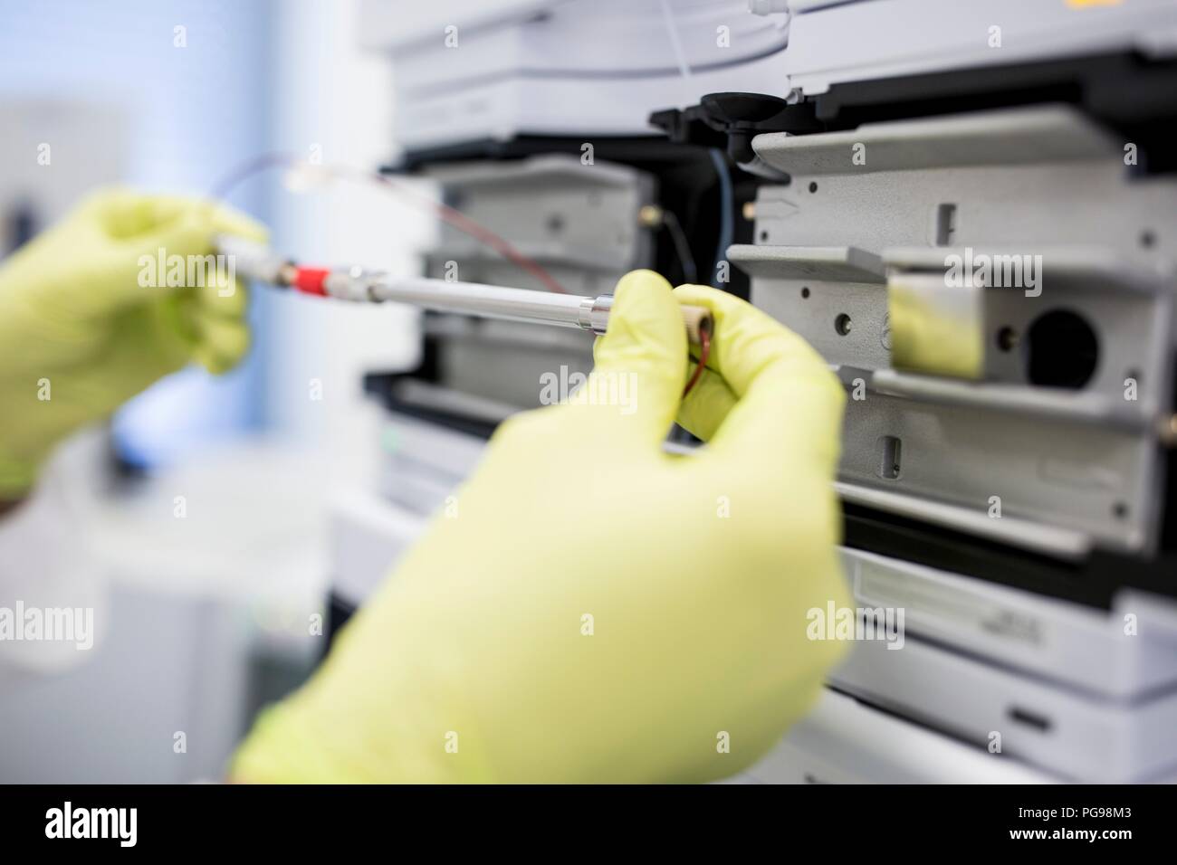 Glass column containing a solution for calibrating a mass spectrometer. Mass spectrometry uses strong magnetic and electric fields to separate the components of a sample by mass and charge. This enables researchers to determine the elemental composition of the sample. Stock Photo