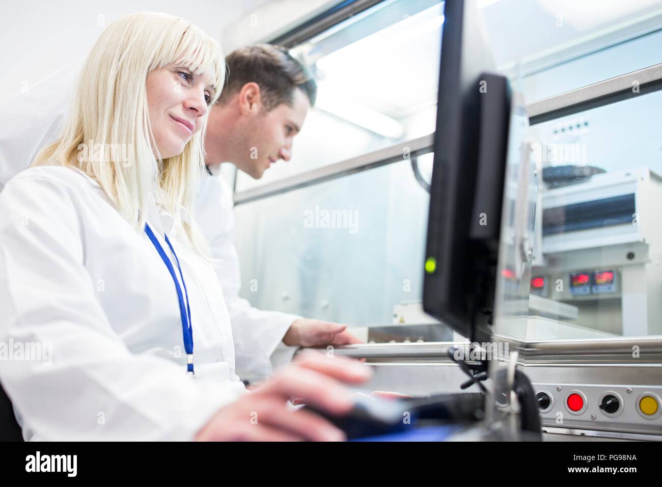 Scientists using a 3D biological printer. The machine can use a range of biomaterial to print tissue-like structures. Stock Photo