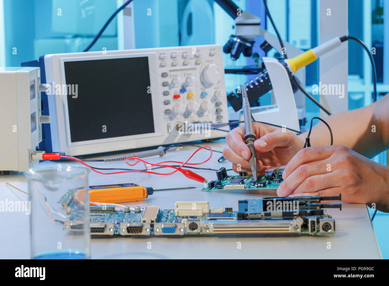 Repairing printed circuit board. Stock Photo