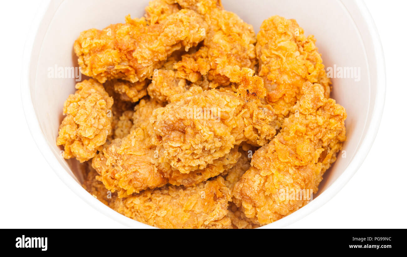 many crispy batter deepfried chicken wings in paper bucket isolated on