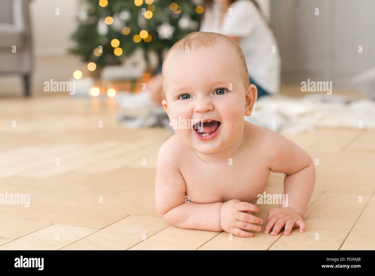 Baby lying on floor and looking at camera Stock Photo