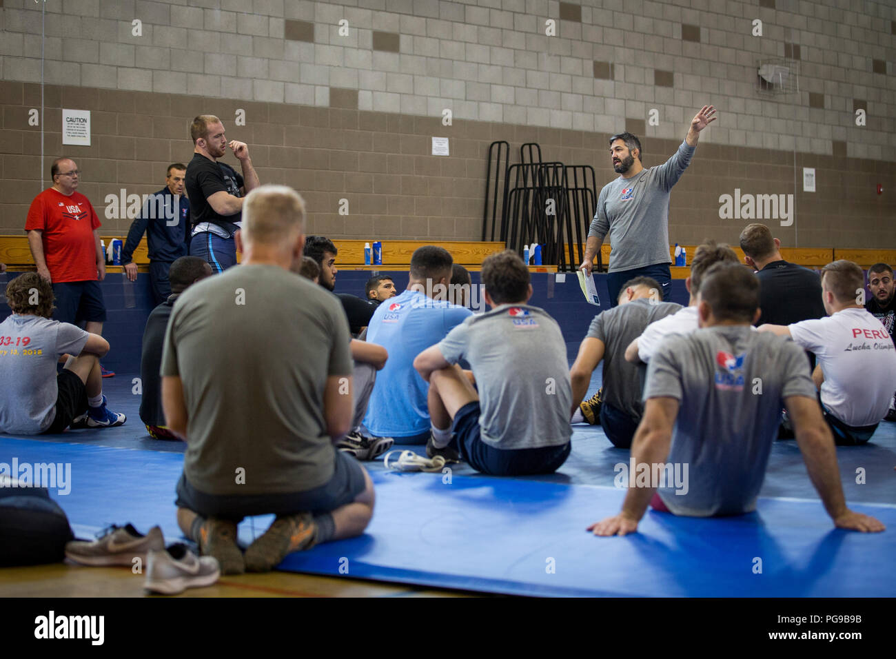 Bill Zadick, right, USA Wrestling’s National Freestyle coach, USA Wrestling Men’s Freestyle World Team Training Camp, speaks to the wrestlers prior to practice at the 43 Fitness Center at Marine Corps Base Camp Pendleton, California, Aug. 20, 2018.  During his first year of coaching, Zadick successfully led his team to the World Team Title at the World Championships in 2017. (U.S. Marine Corps photo by Lance Cpl. Betzabeth Y. Galvan) Stock Photo