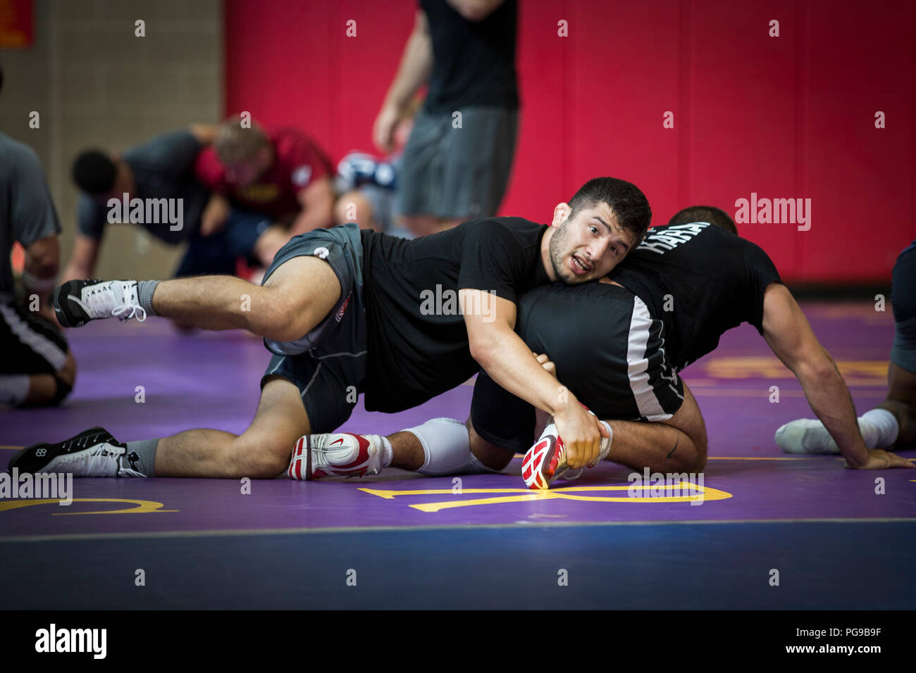 Isaiah Martinez, left, wrestler, USA Wrestling Men’s Freestyle World Team, attempts to subdue his training partner at the 43 Fitness Center at Marine Corps Base Camp Pendleton, California, Aug. 20, 2018. Prior to training the wrestlers warm-up, which included a series of roles, work-outs and stretches, helped them maintain flexibility and avoid potential injuries caused by tight muscles. (U.S. Marine Corps photo by Lance Cpl. Betzabeth Y. Galvan) Stock Photo