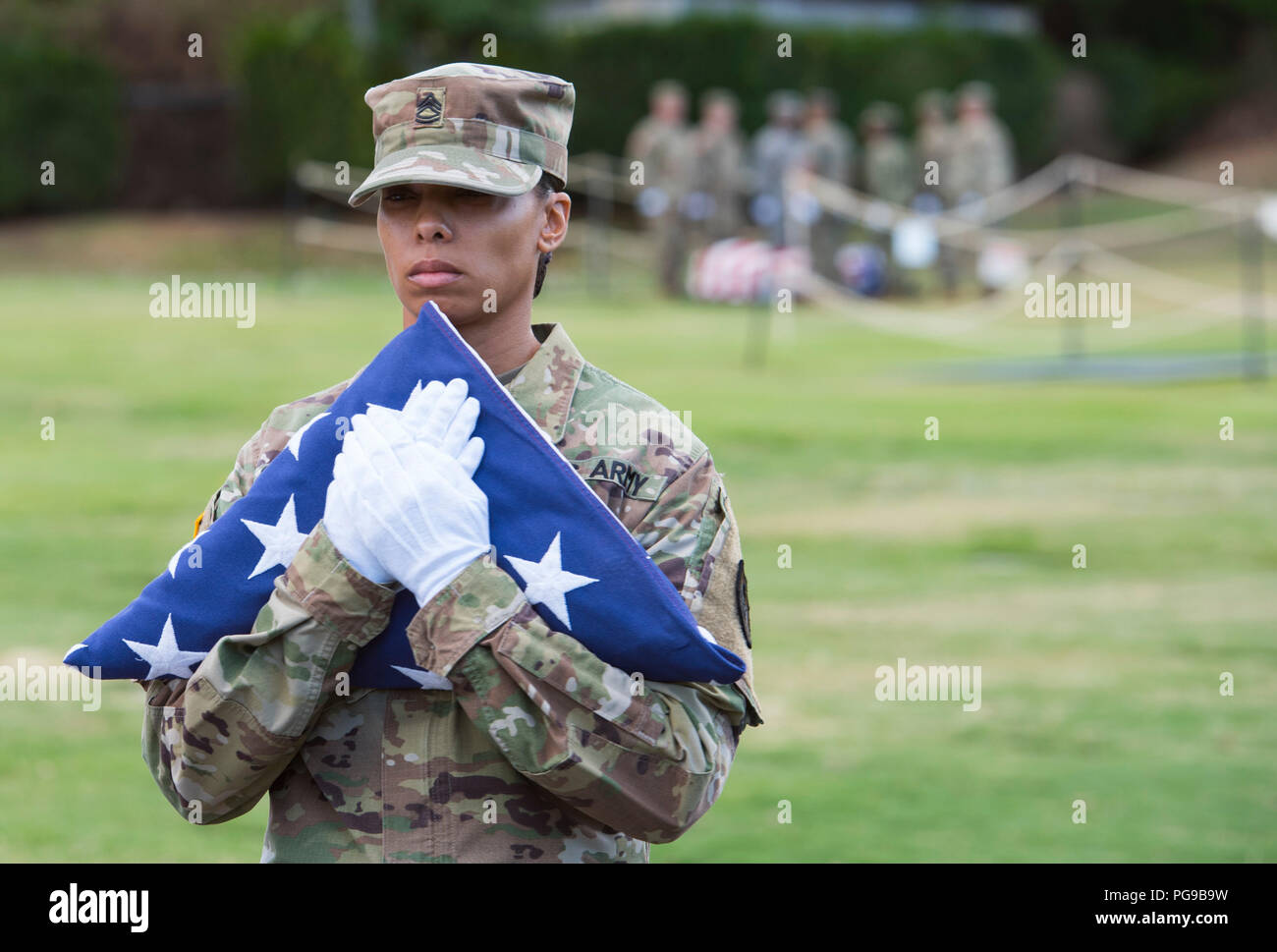 U.s. Army Sgt. 1St Class Jacklyn Sosa, With The Defense Pow/Mia Accounting  Agency (Dpaa), Carries The American Flag During A Disinterment Ceremony At  The National Memorial Cemetery Of The Pacific, Honolulu, Hawaii,