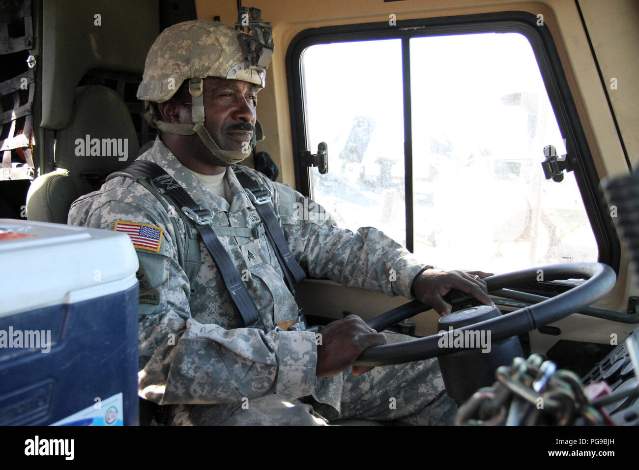Sgt. Jerome Lee, a light-wheeled mechanic with Echo Company, 328th Brigade Support Battalion, 56th Stryker Brigade Combat Team, 28th Infantry Division, Pennsylvania Army National Guard, gets ready to drive a light medium tactical vehicle in a convoy from the National Training Center, Fort Irwin to the railhead in Yermo, California Aug. 19. After the 56th SBCT finishes the combat training rotation at NTC, the vehicles belonging to the Pennsylvania Guard must then be transported via train to Mechanicsburg, Pennsylvania, where they will be returned to their home units. (U.S. Army National Guard p Stock Photo
