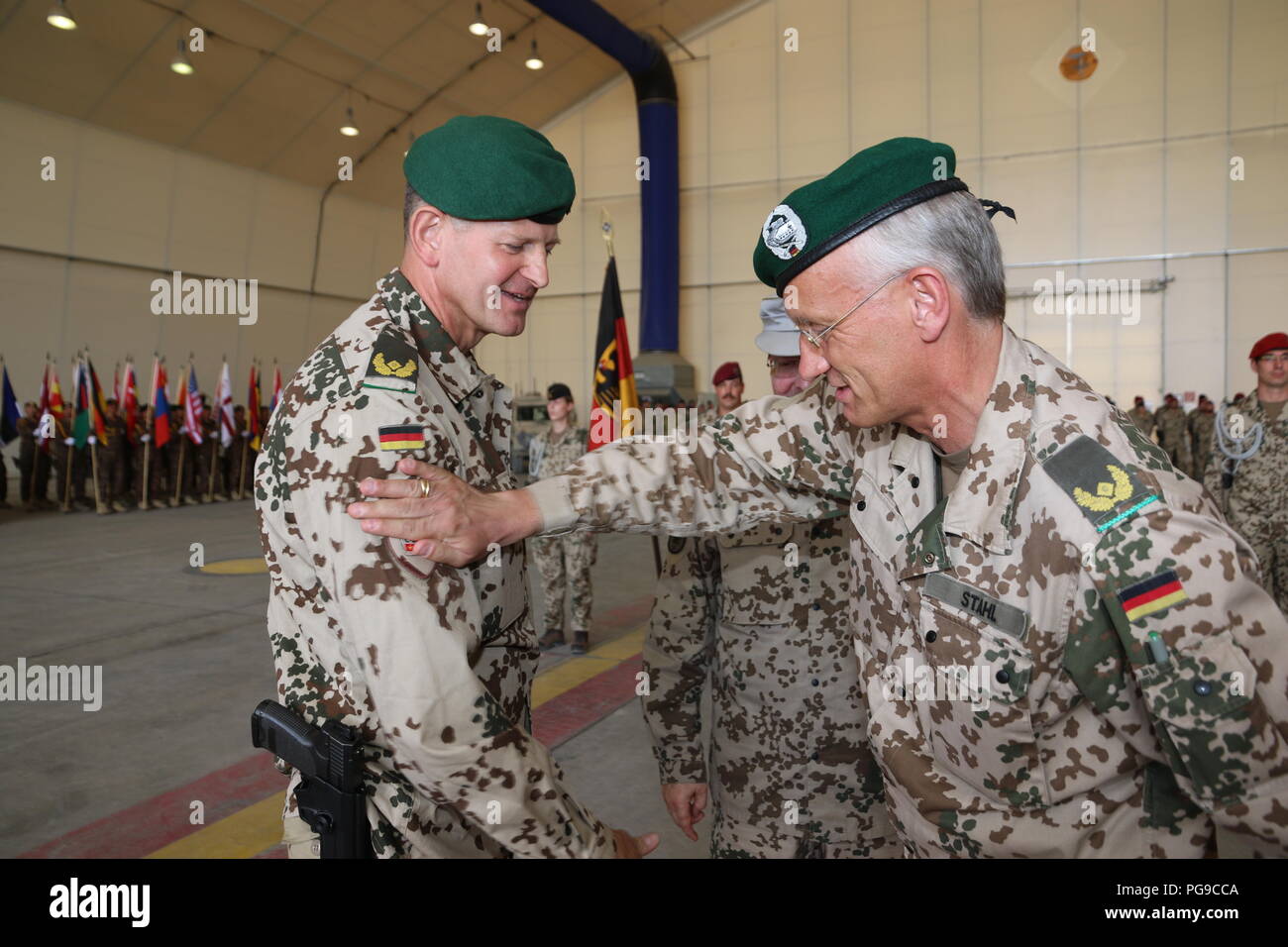 German Army Brig. Gen. Wolf-Jürgen Stahl (right), hands over the symbolic badge “commander TAAC-North” to his successor, German Army Brig. Gen. Ernst-Peter Klaffus, on August 21, 2018 at TAAC-North in Mazer-e Sharif, Afghanistan. Stahl took command of TAAC-North in October 2017. Stock Photo