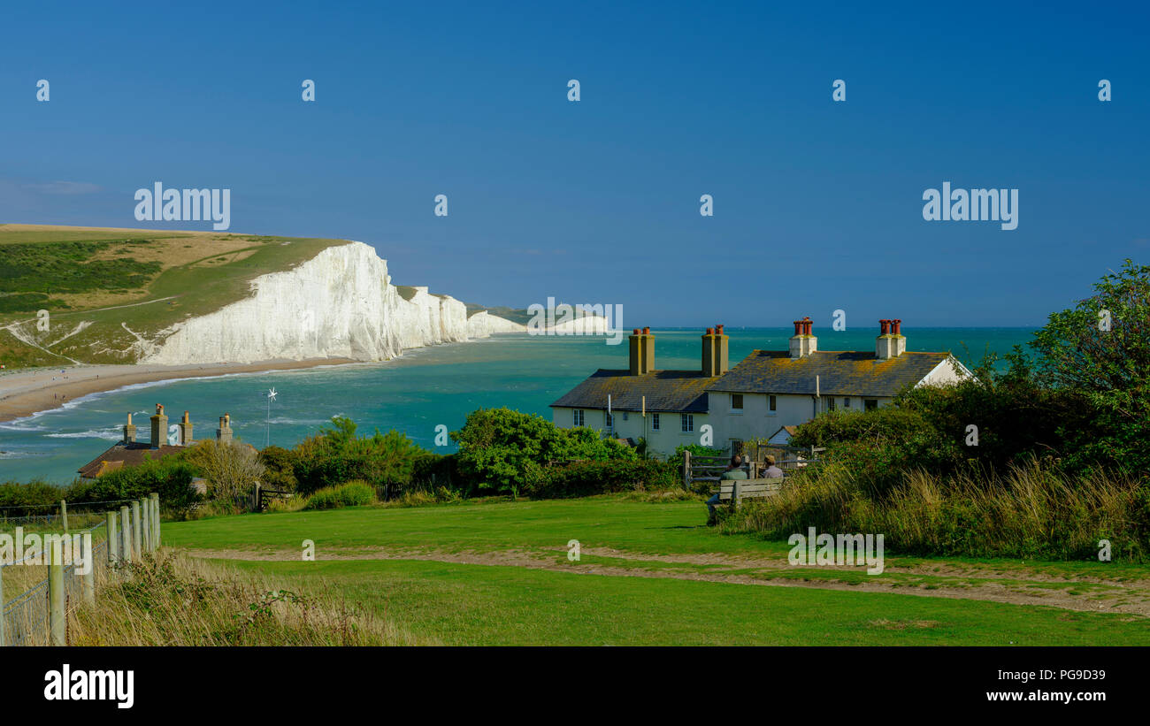 Summer afternoon light on the Severn Sisters white cliffs and the Coast Guard cottages at Cuckmere, in the South Downs National Park, East Sussex, UK Stock Photo