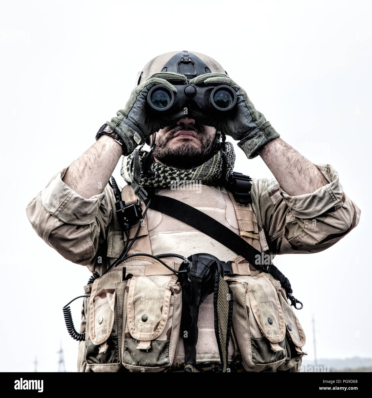 Commando soldier using binoculars to observe terrain Stock Photo - Alamy