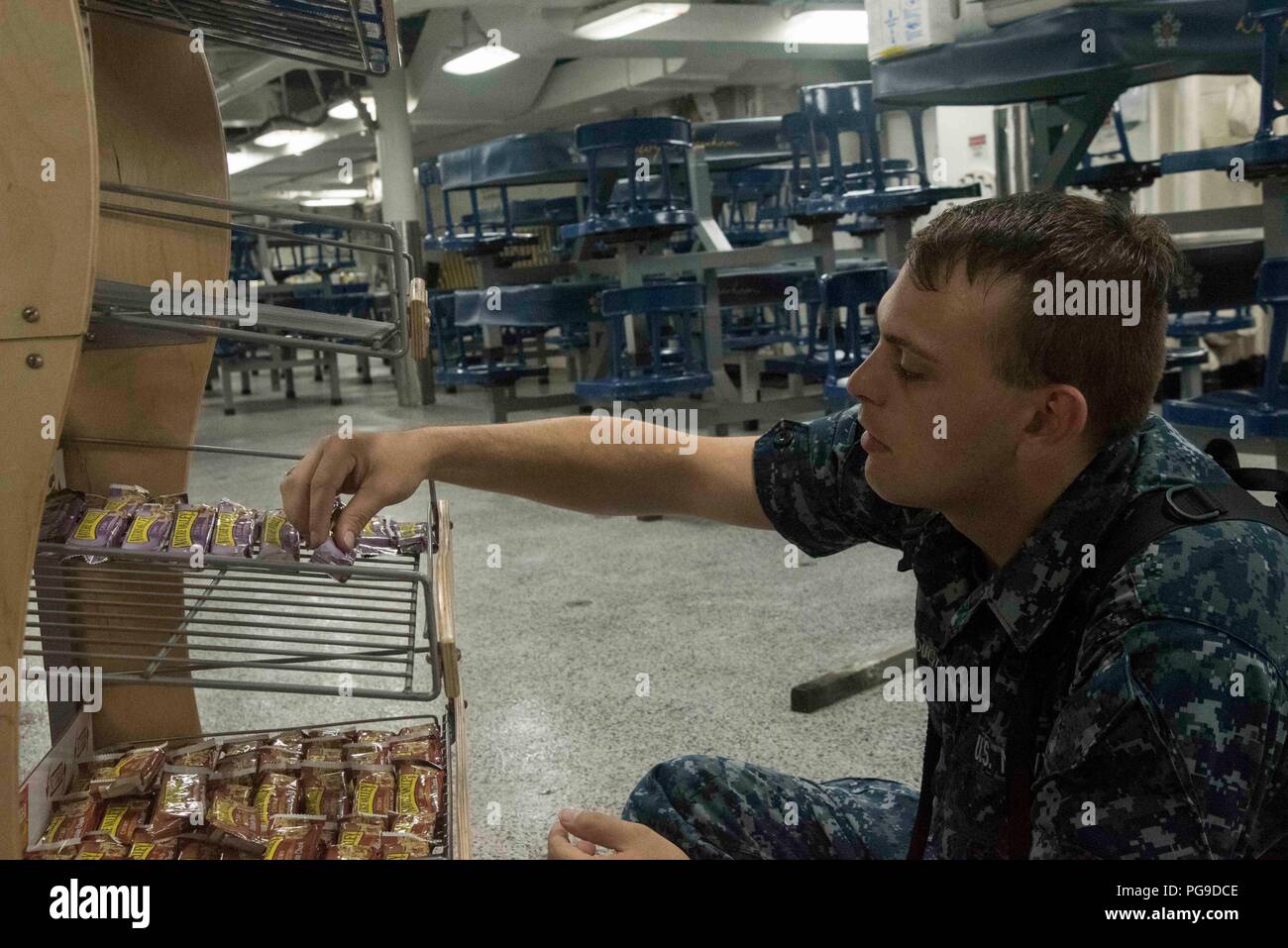 180821-N-MY760-001   PORTSMOUTH, Va. (Aug. 21, 2018)Culinary Specialist Seaman Apprentice Jesse Yarbrough-Lane, from Knoxville, Ten., restocks the galley aboard the aircraft carrier USS Dwight D. Eisenhower (CVN 69)(Ike). Ike is undergoing a Planned Incremental Availability (PIA) at Norfolk Naval Shipyard during the maintenance phase of the Optimized Fleet Response Plan (OFRP). (U.S. Navy photo by Mass Communication Specialist Seaman Apprentice Tyler Miller) Stock Photo