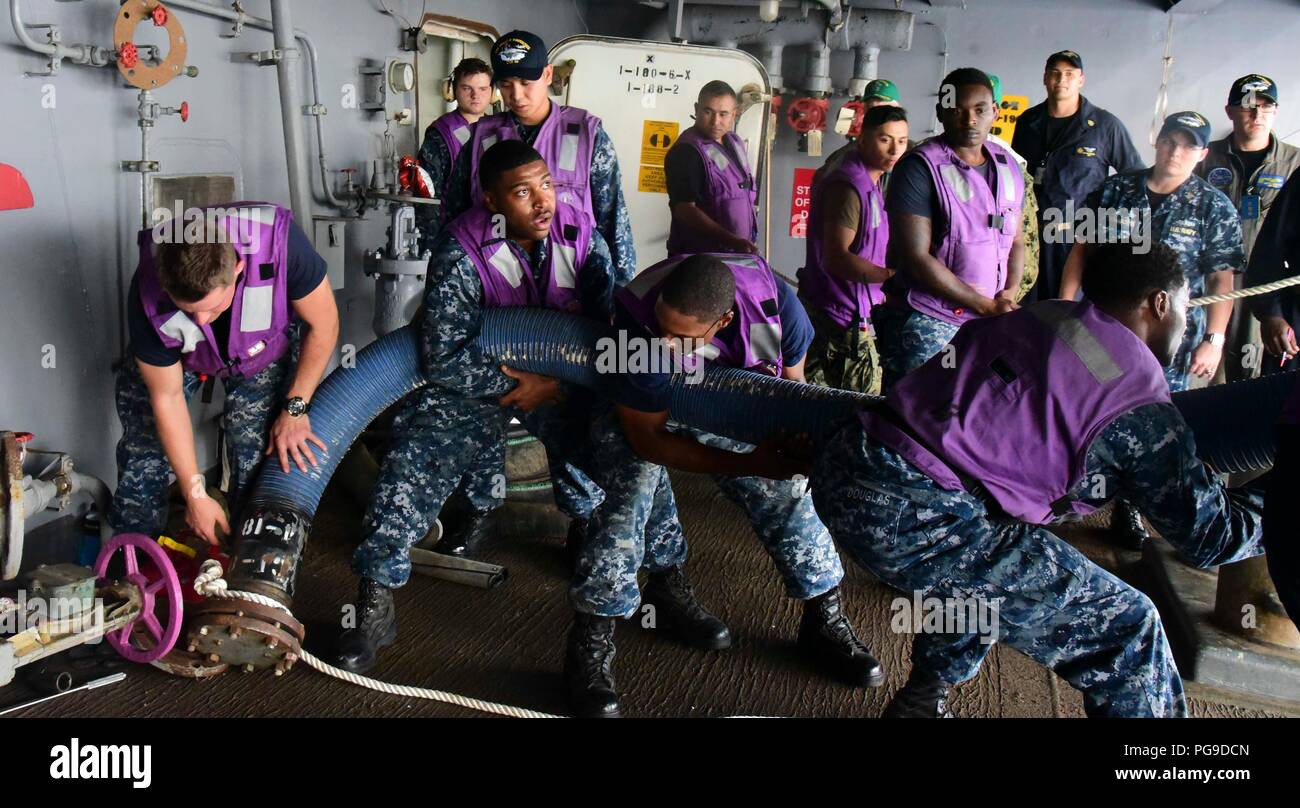180821-N-MY760-133 1   PORTSMOUTH, Va. (Aug. 21, 2018) Sailors aboard the aircraft carrier USS Dwight D. Eisenhower (CVN 69)(Ike) pull aboard a refueling hose. Ike is undergoing a Planned Incremental Availability (PIA) at Norfolk Naval Shipyard during the maintenance phase of the Optimized Fleet Response Plan (OFRP). (U.S. Navy photo by Mass Communication Specialist Seaman Apprentice Tyler Miller) Stock Photo