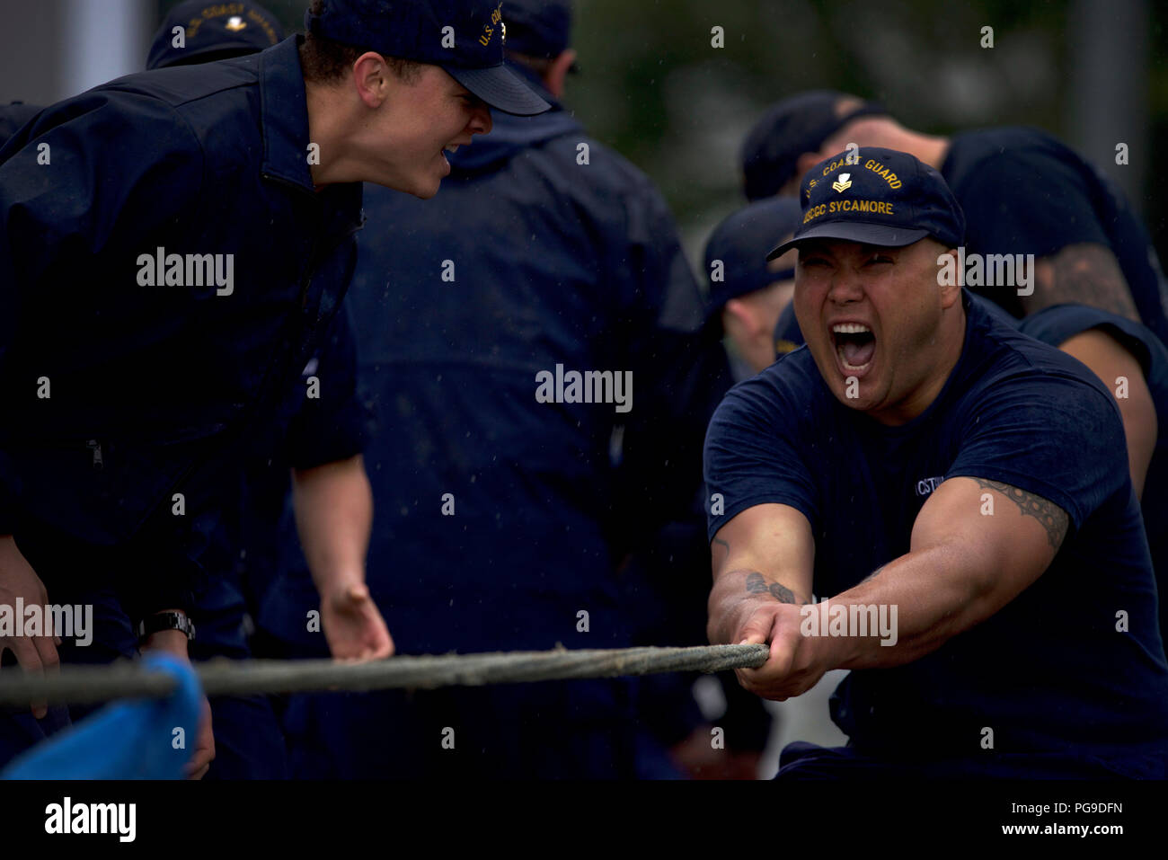 Members of the Coast Guard Cutter Sycamore fight passed the point of exhaustion during the tug-o-war competition as part of the Buoy Tender Olympics at Coast Guard Station Juneau, Alaska, Aug. 22, 2018. The Olympics is a competition that not only builds morale amongst cutter members but also provides a fun alternative to every day training in events such as the chain pull, survival swim and the heat-and-beat. U.S. Coast Guard photo by Petty Officer 1st Class Jon-Paul Rios. Stock Photo