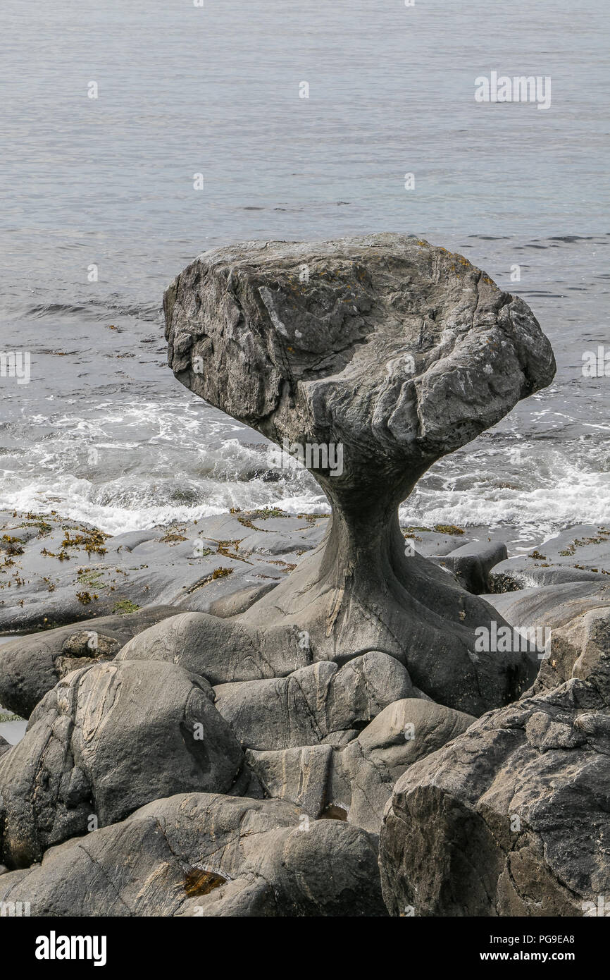 Famous Kannesteinen - a coastal rock with a very characteristic shape, located near Maloy, Norway. Stock Photo