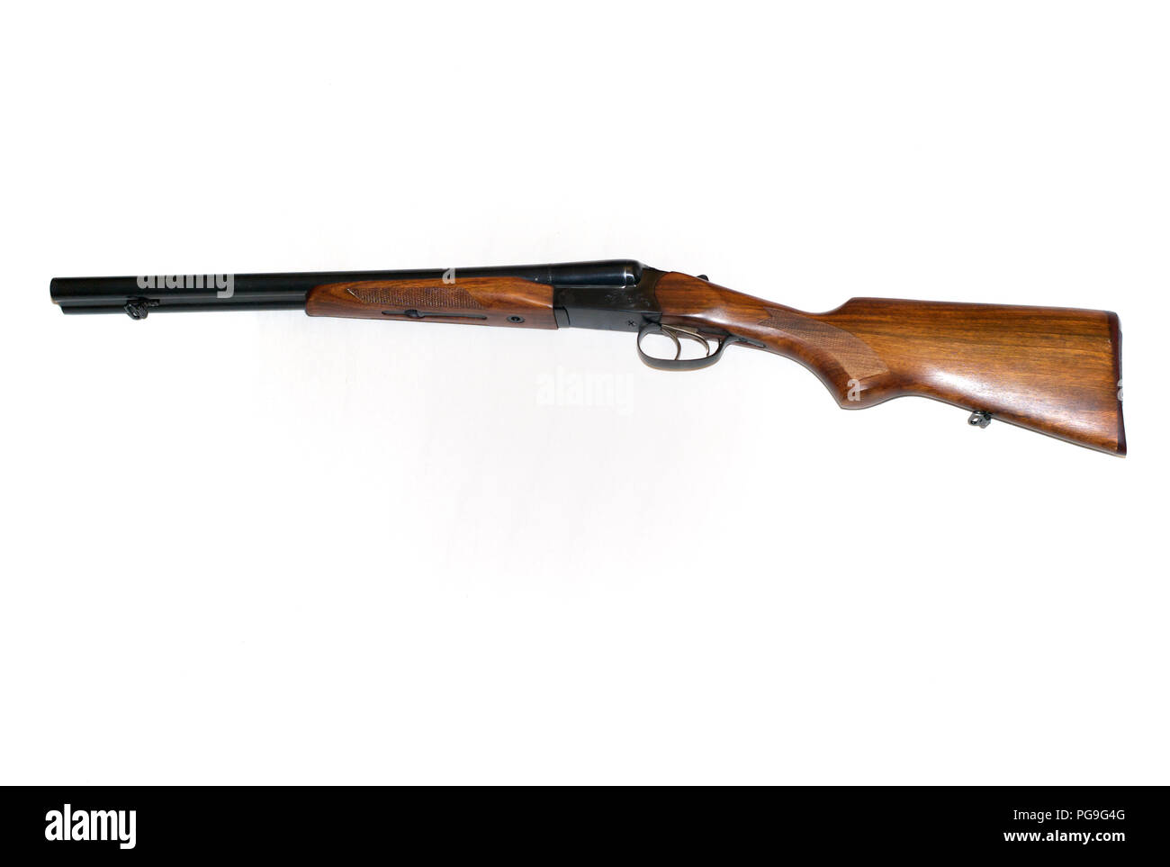 Double Barrel Shotgun, Side by Side Gun with Blued Barrels and Wooden Stock on White Background Stock Photo