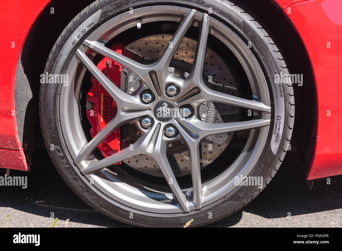 An alloy wheel of a Ferrari sports car, clearly showing the brake disc