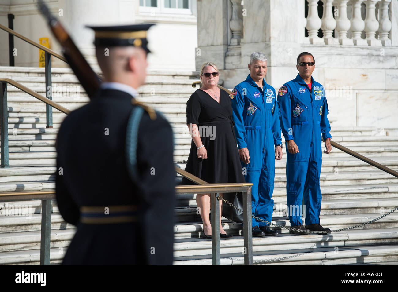 NASA astronaut Mark Vande Hei, center, his wife Julie, left, and NASA  astronaut Joe Acaba witness the changing of the guards at the Tomb of the  Unknown soldier, Friday, June 15, 2018