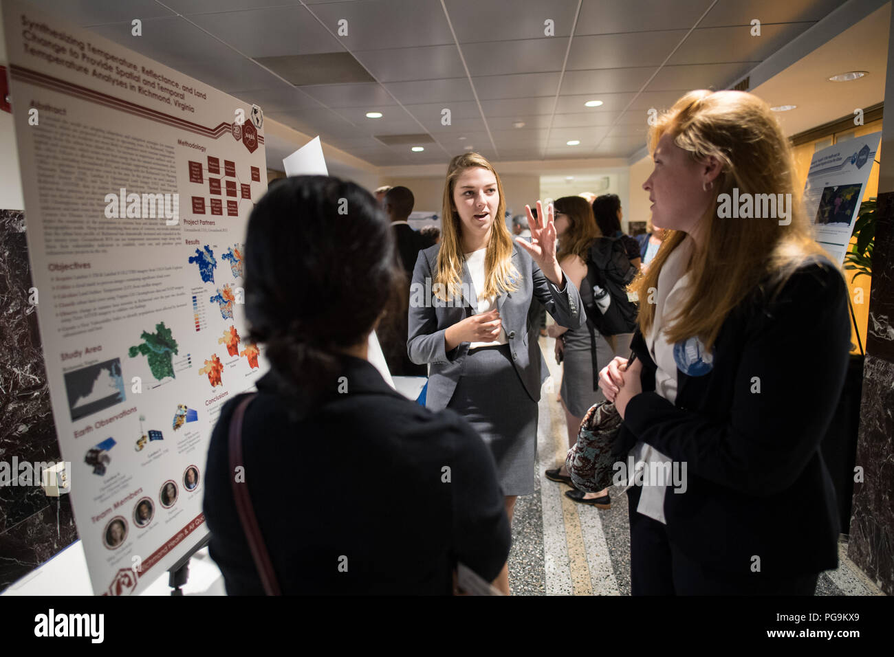 Students and young professionals discuss their projects at the Earth Science Applications Showcase Wednesday, August 1, 2018 at NASA Headquarters in Washington. Every summer, participants in NASA’s Applied Sciences’ DEVELOP National Program come to NASA Headquarters and present their research projects. DEVELOP is a training and development program where students work on Earth science research projects, mentored by science advisers from NASA and partner agencies, and extend research results to local communities. Stock Photo