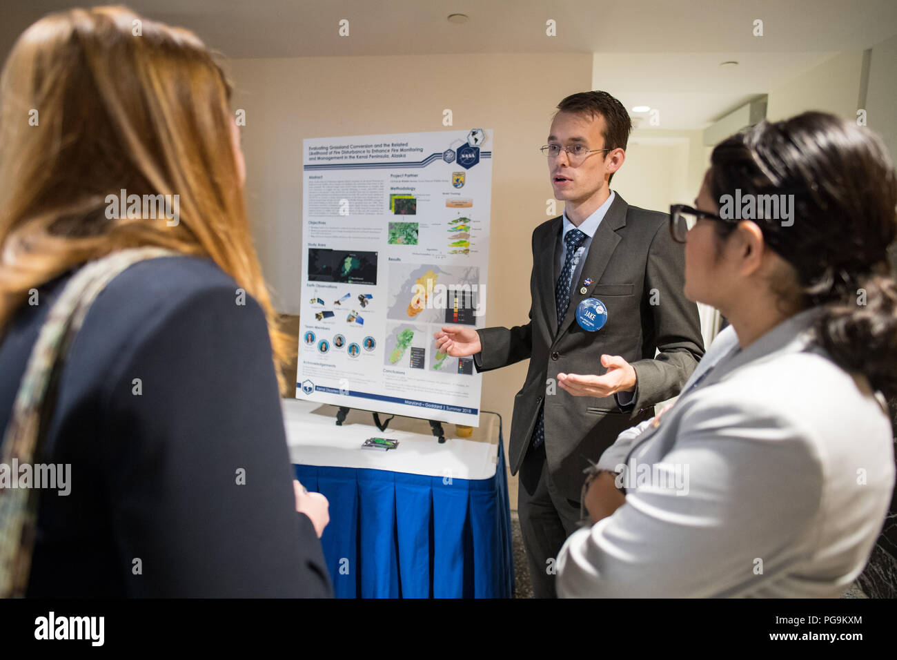 Students and young professionals discuss their projects at the Earth Science Applications Showcase Wednesday, August 1, 2018 at NASA Headquarters in Washington. Every summer, participants in NASA’s Applied Sciences’ DEVELOP National Program come to NASA Headquarters and present their research projects. DEVELOP is a training and development program where students work on Earth science research projects, mentored by science advisers from NASA and partner agencies, and extend research results to local communities. Stock Photo