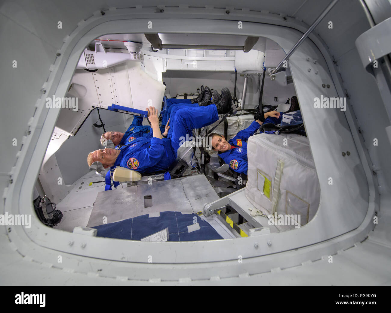 NASA astronauts Eric Boe, foreground left, and Nicole Mann, foreground right, along with Boeing astronaut Chris Ferguson, background, pose for a photograph inside the Boeing Mockup Trainer at NASA’s Johnson Space Center in Houston, Texas on Aug. 2, 2018 ahead of the commercial crew flight assignments announcement Aug. 3. The three were assigned to launch aboard Boeing’s CST-100 Starliner on the company’s Crew Flight Test targeted for mid-2019 in partnership with NASA’s Commercial Crew Program. Stock Photo