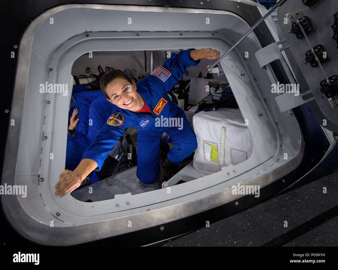 NASA astronaut Nicole Mann poses for a photograph as she exits the Boeing Mockup Trainer at NASA’s Johnson Space Center in Houston, Texas on Aug. 2, 2018 ahead of the commercial crew flight assignments announcement Aug. 3. Mann, along with NASA astronaut Eric Boe and Boeing astronaut Chris Ferguson were assigned to launch aboard Boeing’s CST-100 Starliner on the company’s Crew Flight Test targeted for mid-2019 in partnership with NASA’s Commercial Crew Program. Stock Photo