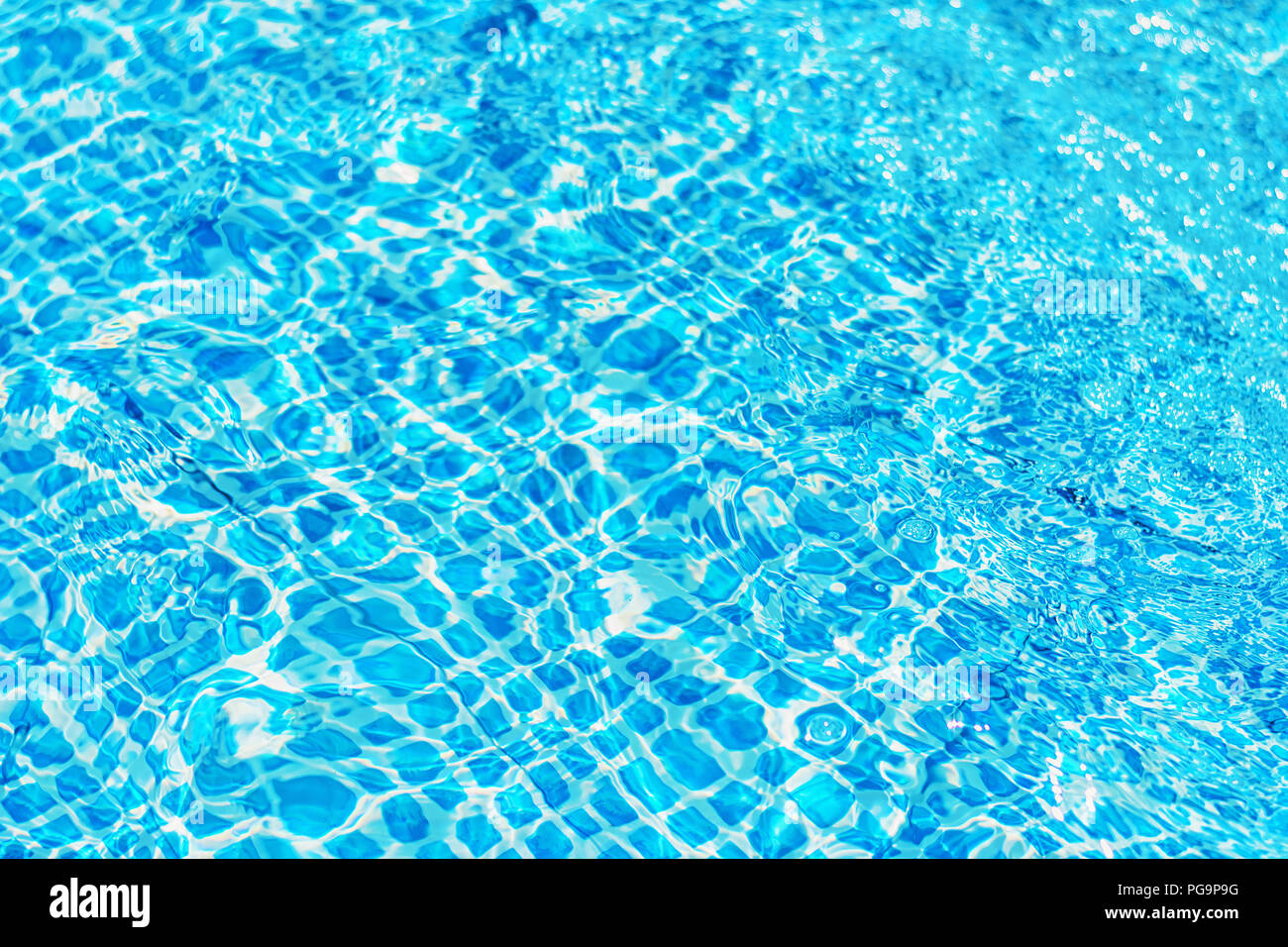 surface of ripple water in blue swimming pool with sun reflection Stock ...