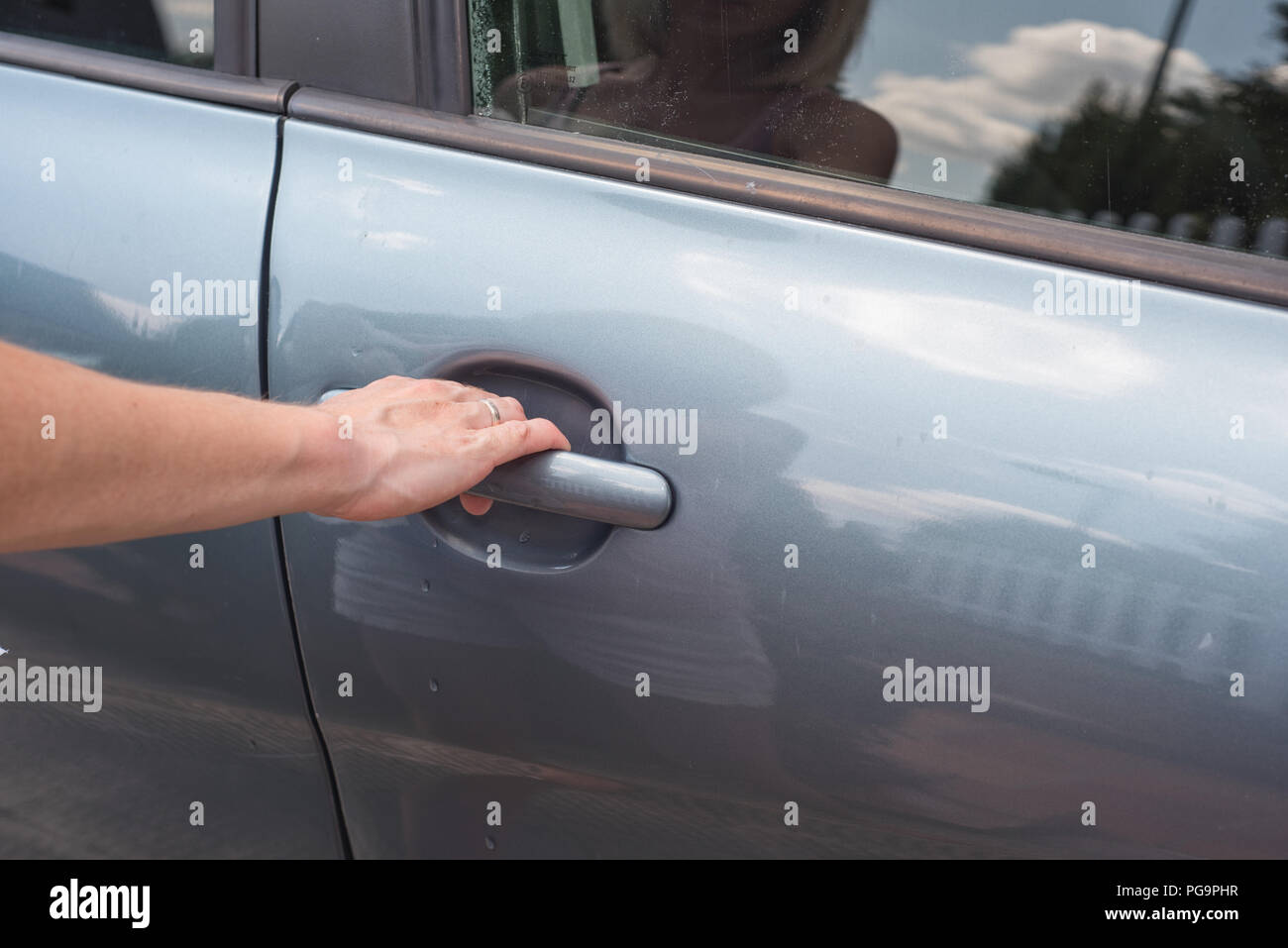 Girl opening door with key hires stock photography and images Alamy