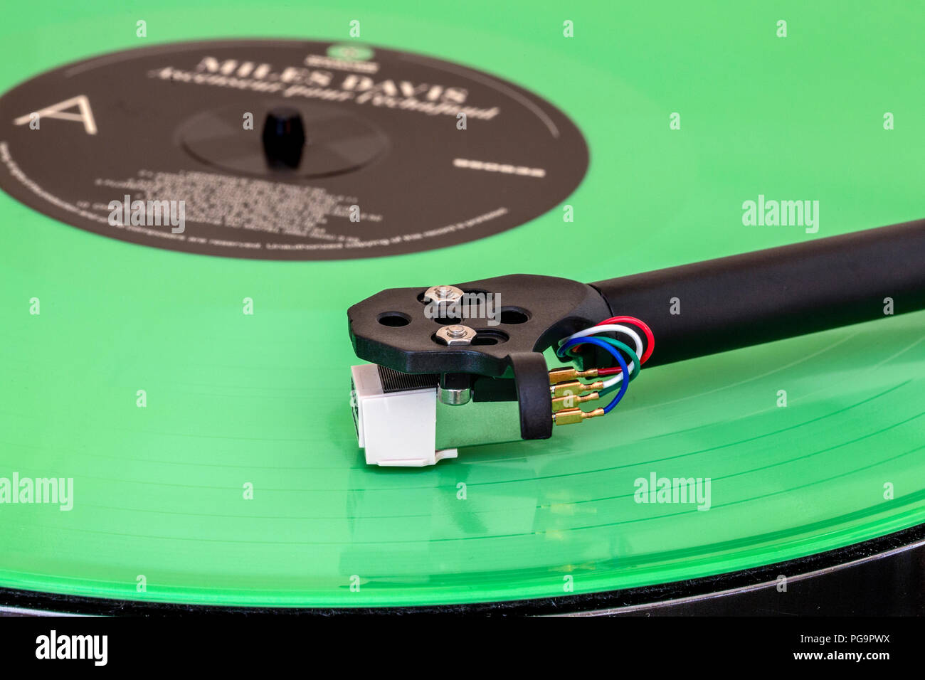 Hifi turntable with tonearm, cartridge and stylus playing on color vinyl record Stock Photo