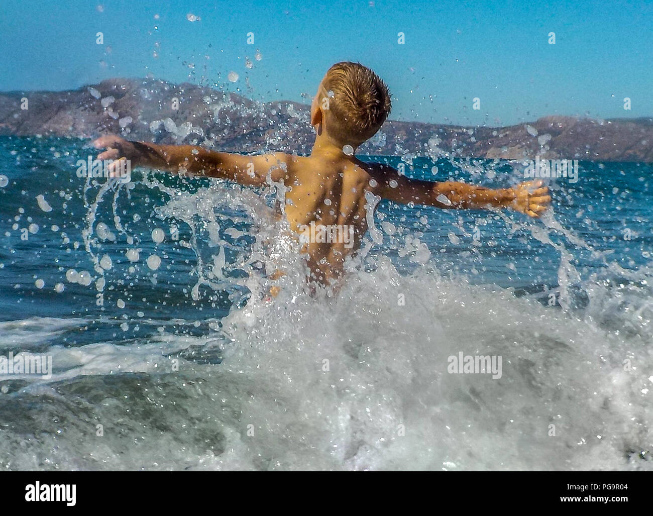 Delighted boy having fun at the seaside Stock Photo