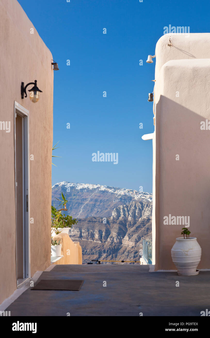 View between two buildings from the south of Santorini to the center with the villages on the crater rim. Stock Photo