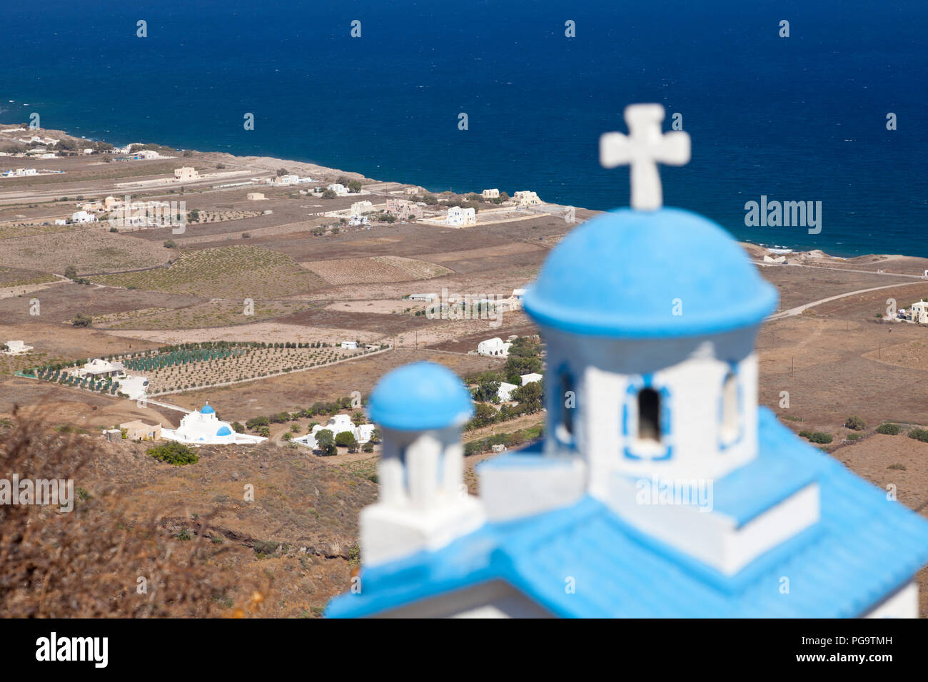 A blue and white chapel model with the northern coastline of Santorini, Greece. Stock Photo