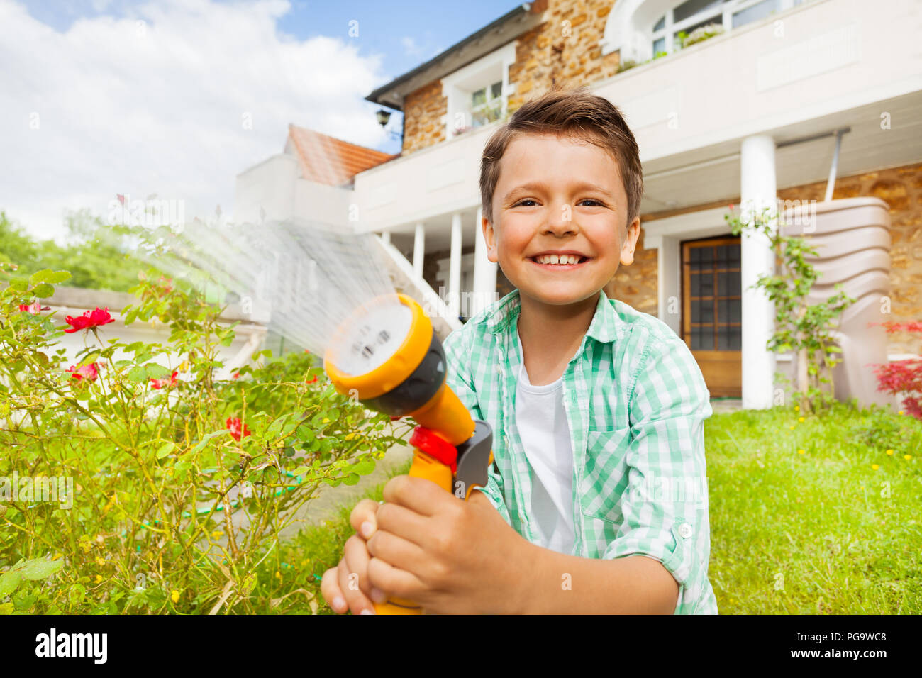 Happy little boy working at garden in summer Stock Photo - Alamy