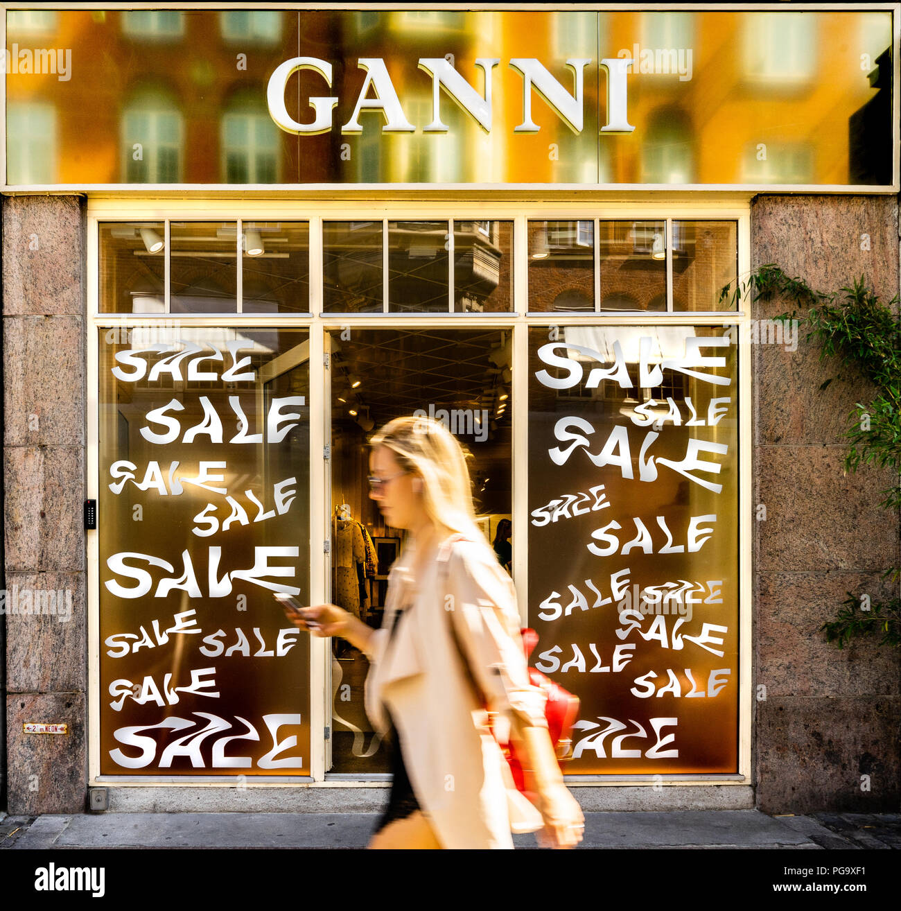 Ganni flagship store in Copenhagen, girl passing by Stock Photo - Alamy