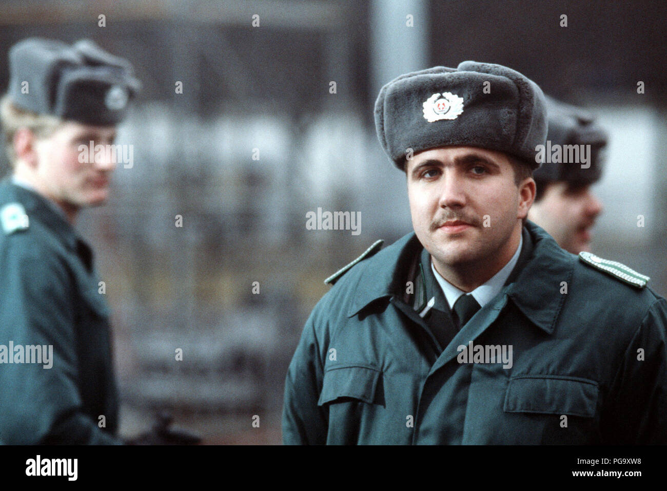 An East German guard observes activities prior to the official opening of the Brandenburg Gate. Stock Photo