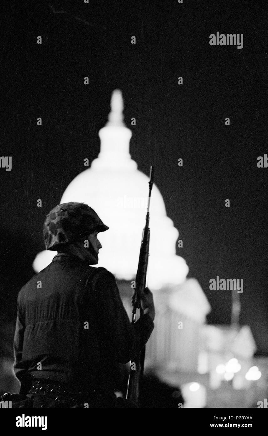 A national guardsman stands watch near the US Capitol building with his ...