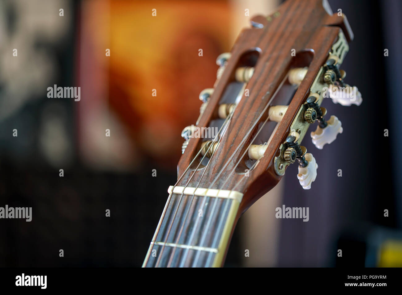 Acoustic guitar head stock with strings and tuning keys Stock Photo
