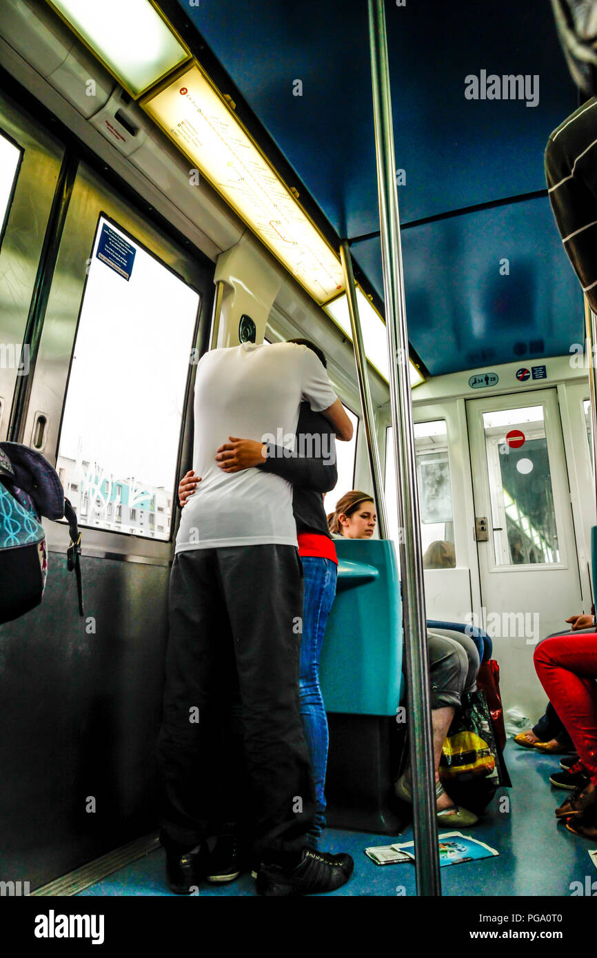 A couple, standing and hugging on the Lille Metro in France Stock Photo