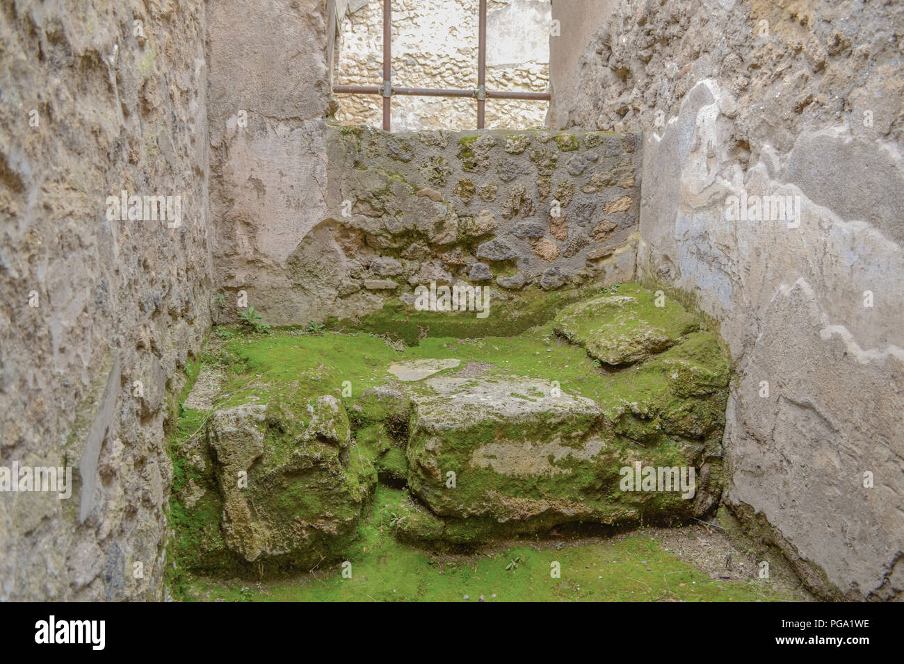 A prostitute's bed covered in moss in the ancient city of Pompeii Stock Photo