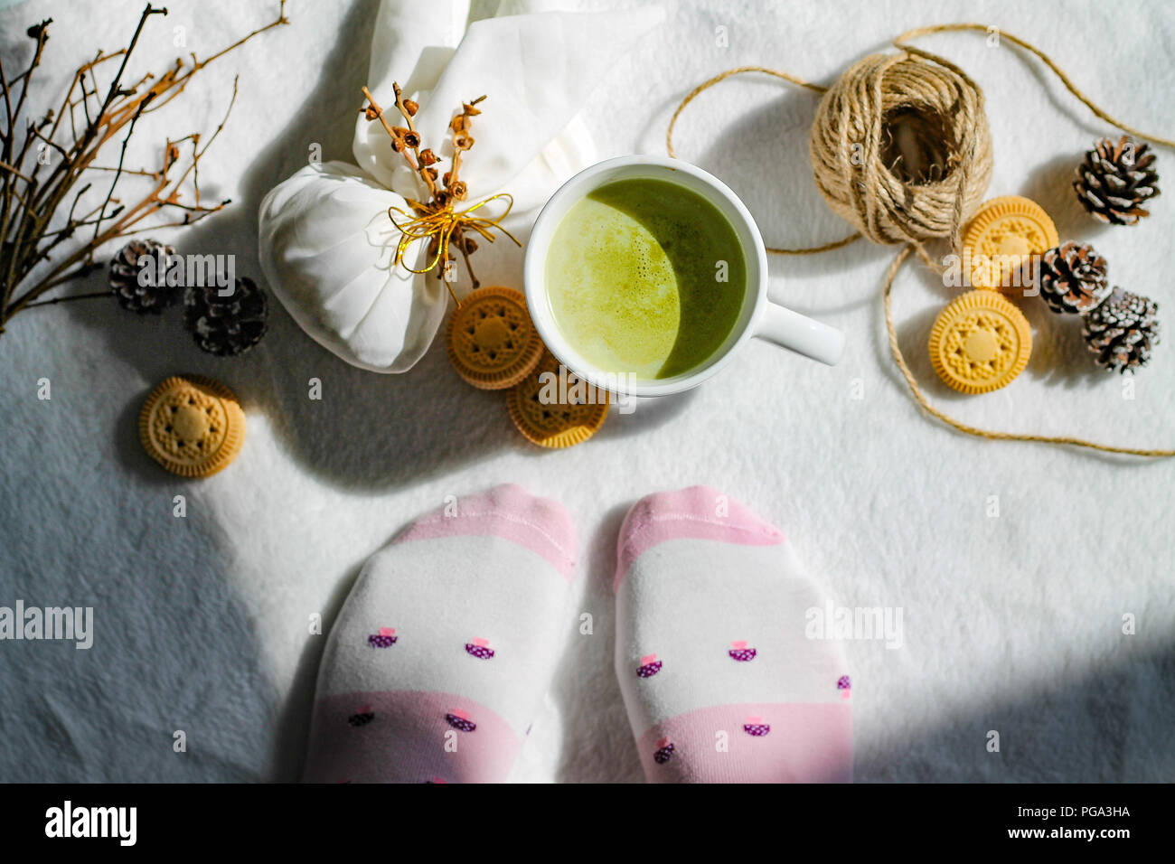 Warm socks and hot beverage to show the warmth and feelings of the autumn and winter season Stock Photo