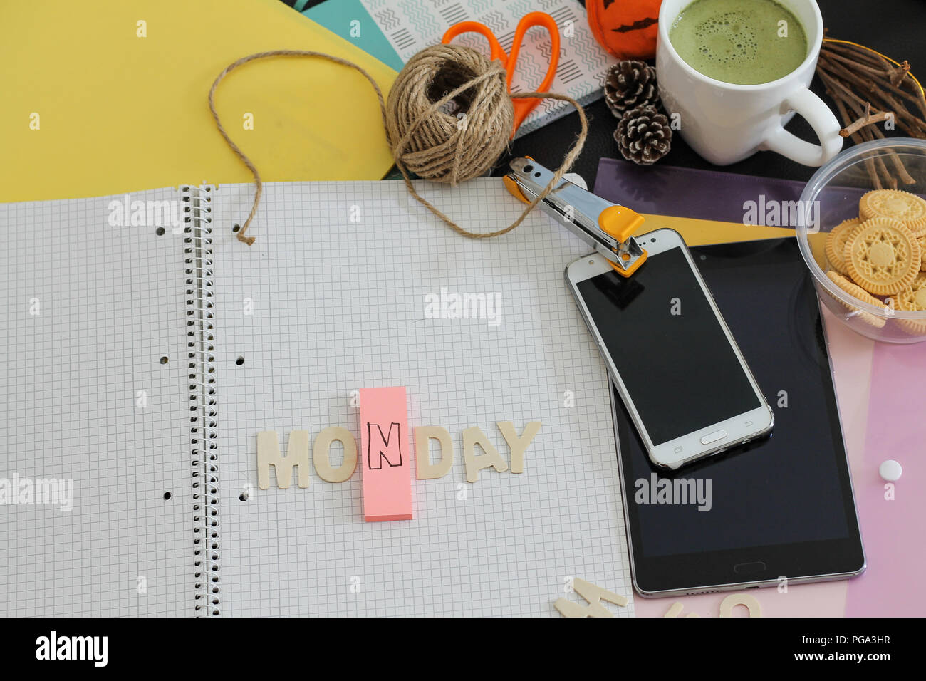 Messy office desk depicting life at a busy office, chasing deadlines and the working millennial life Stock Photo