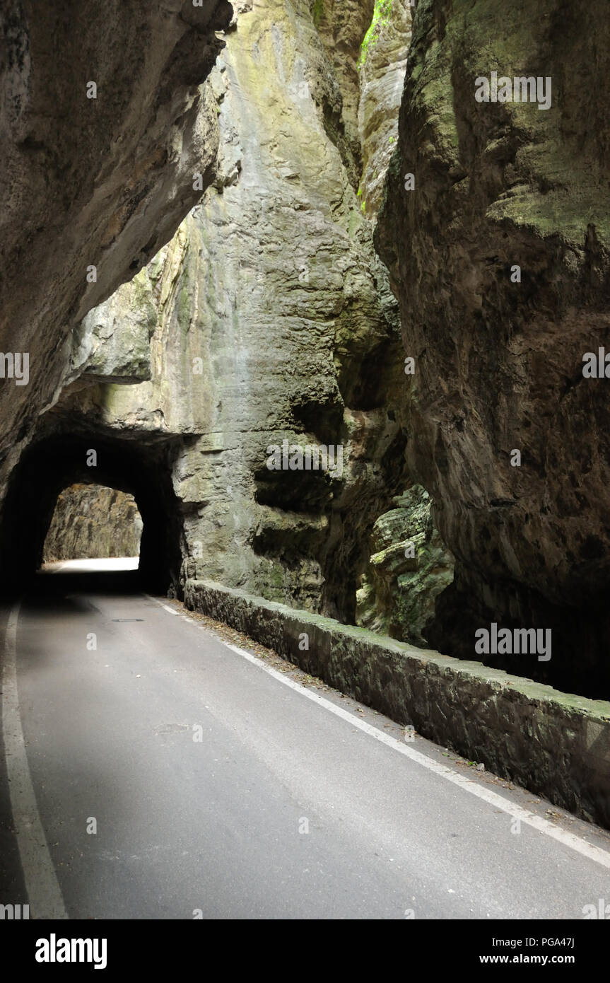 The gorge road, strada della forra, a narrow mountain road with tunnel in a rocky gorge near lago di garda, Italy Stock Photo