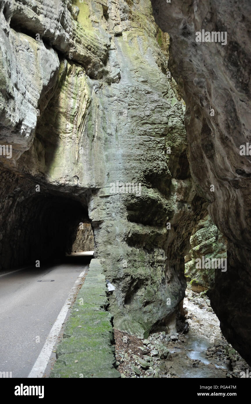 The gorge road, strada della forra, a narrow mountain road with tunnel in a rocky gorge near lago di garda, Italy Stock Photo