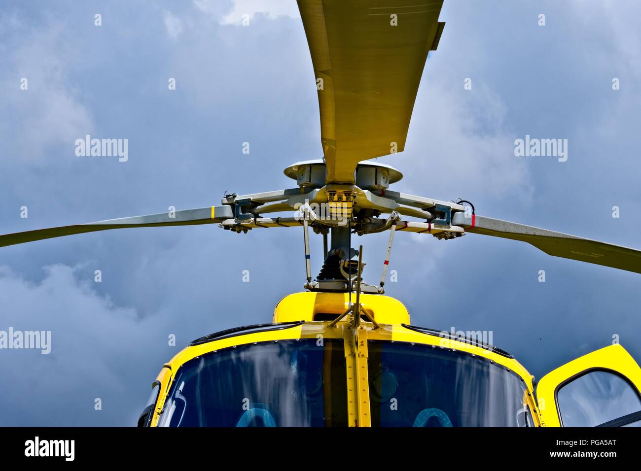 Yellow helicopter close up on the rotors. Air Vehicle, Built Structure, Gold, Helicopter, Manufactured Object Stock Photo
