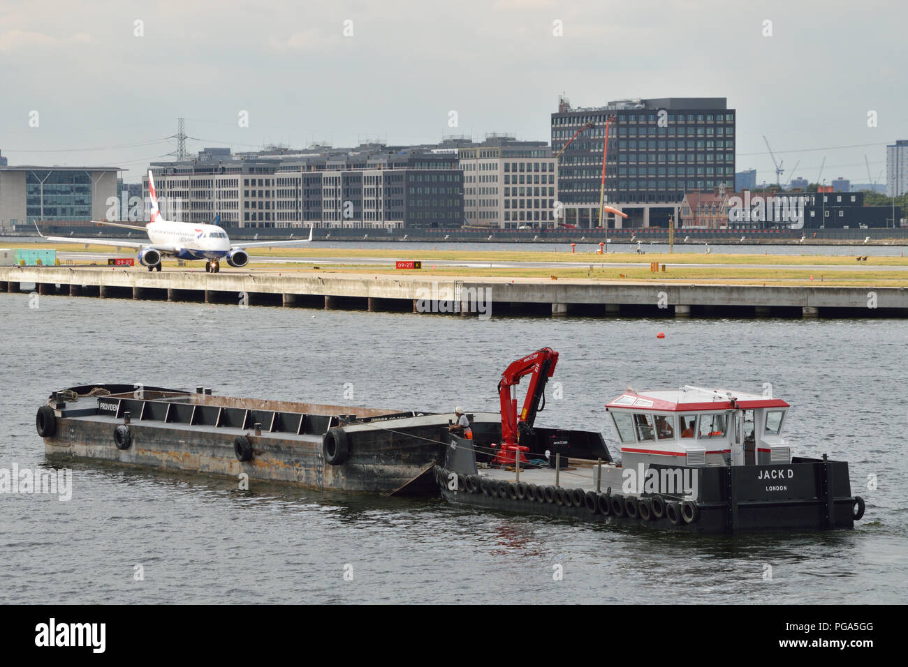 Construction work at London City Airport making use of river transport to move materials to and from the worksite Stock Photo