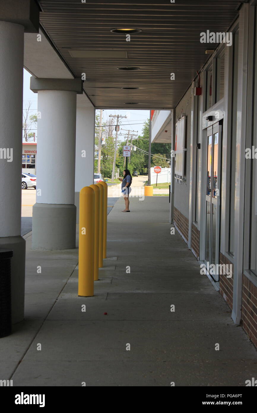 Standard strip mall shopping center in suburban Niles, Illinois, USA on