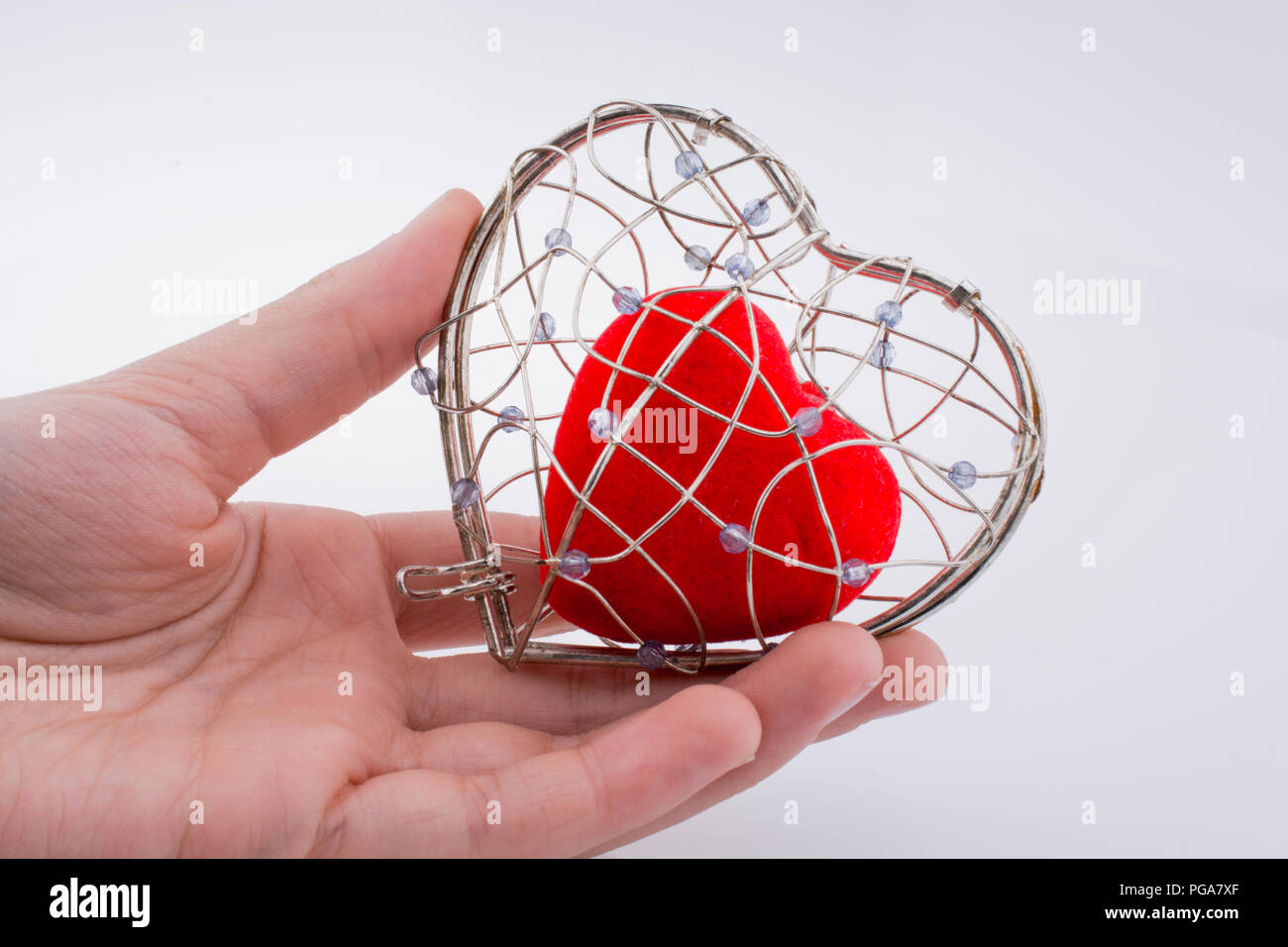Red heart in a heart shaped cage Stock Photo Alamy