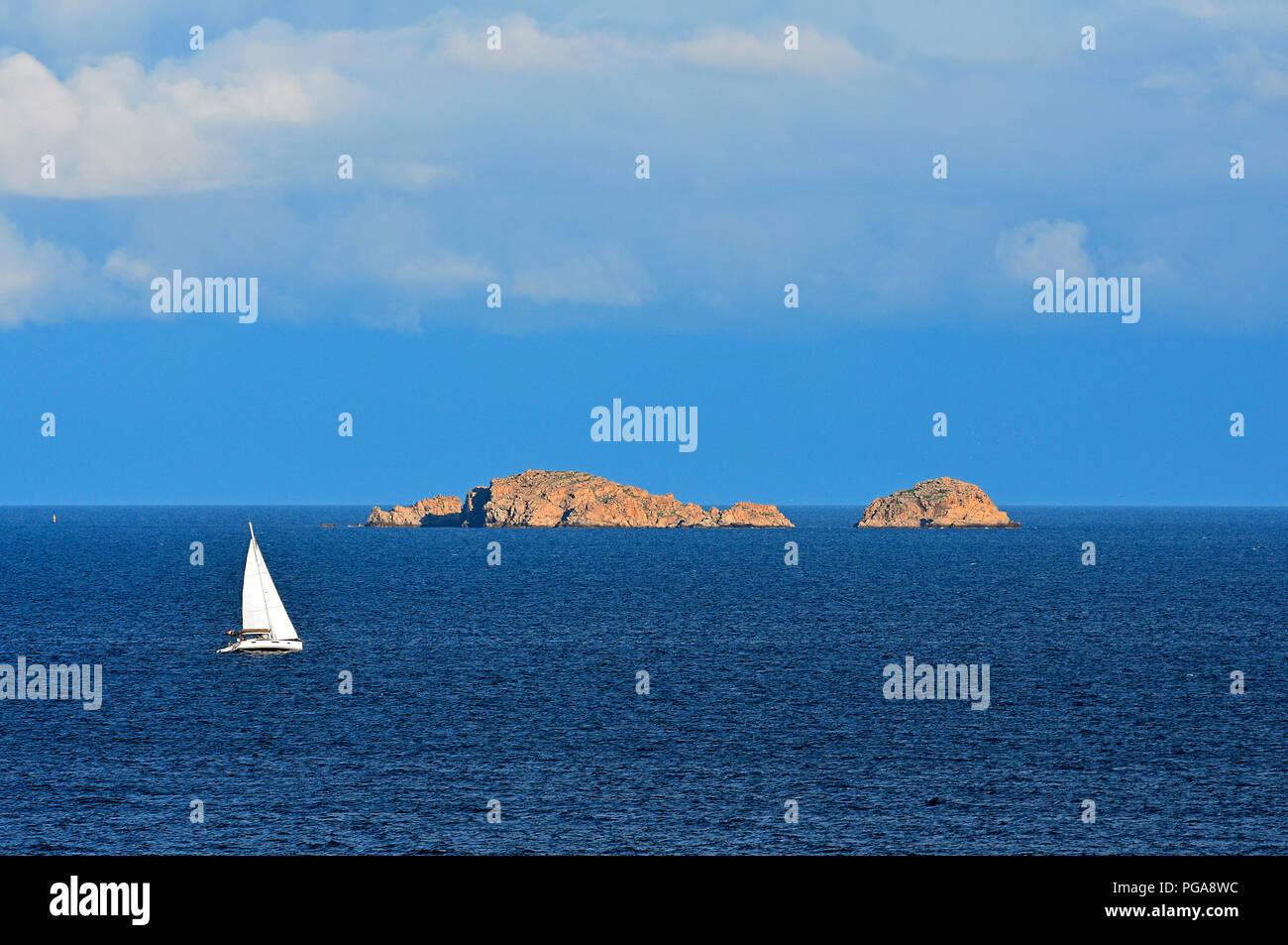 Sailboat in front of rocky islands, Palombaggia beach, Porto Vecchio, Corse-du-Sud department, Corsica, France Stock Photo