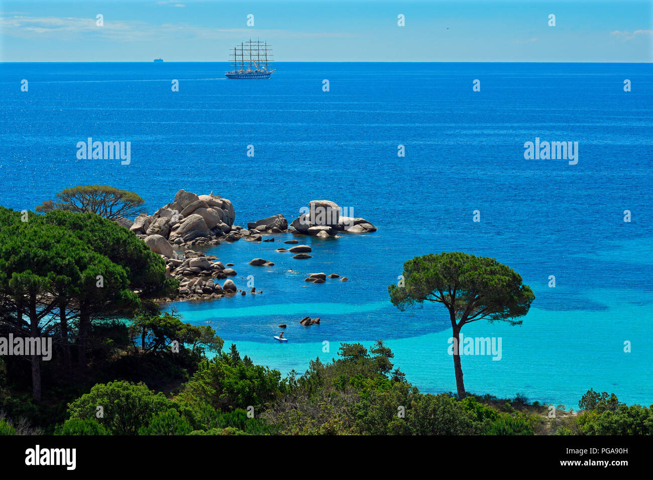 Bay of Palombaggia with turquoise blue sea and sailing ship, Porto Vecchio, Corse-du-Sud department, Corsica, France Stock Photo
